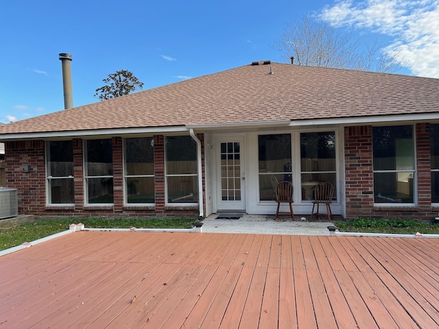 rear view of property with a deck and central air condition unit