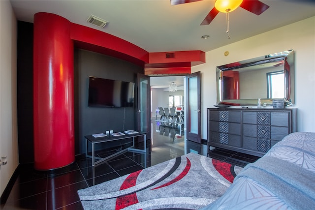 bedroom with dark tile patterned flooring and ceiling fan