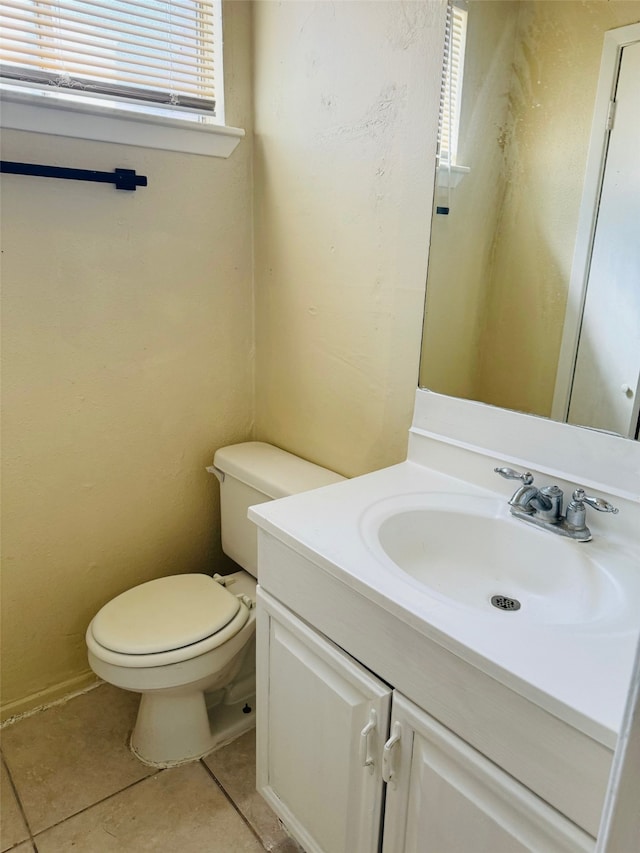 bathroom featuring vanity, toilet, and tile patterned flooring