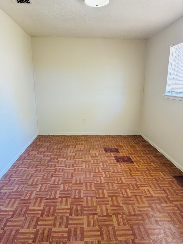 unfurnished room featuring light parquet flooring