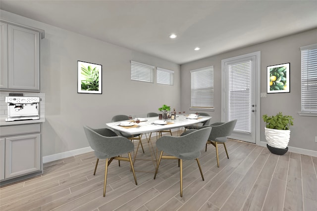 dining room featuring a wealth of natural light and light hardwood / wood-style floors