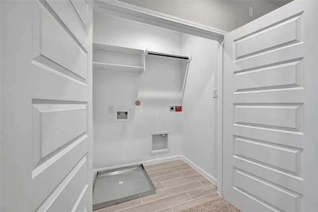 laundry area with hookup for a gas dryer, electric dryer hookup, light hardwood / wood-style floors, and hookup for a washing machine