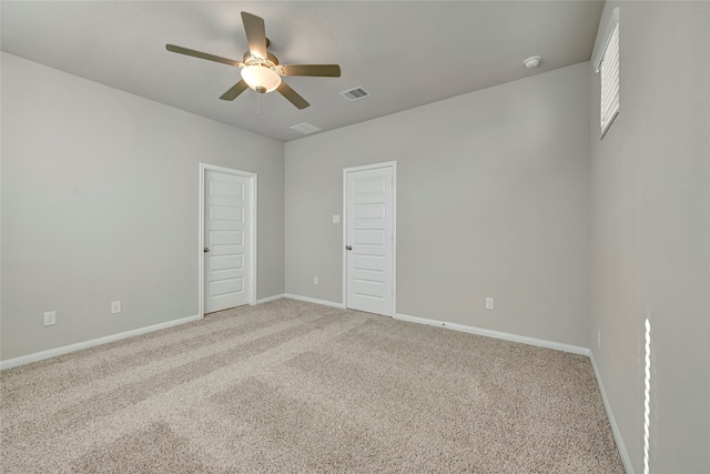 carpeted spare room with ceiling fan