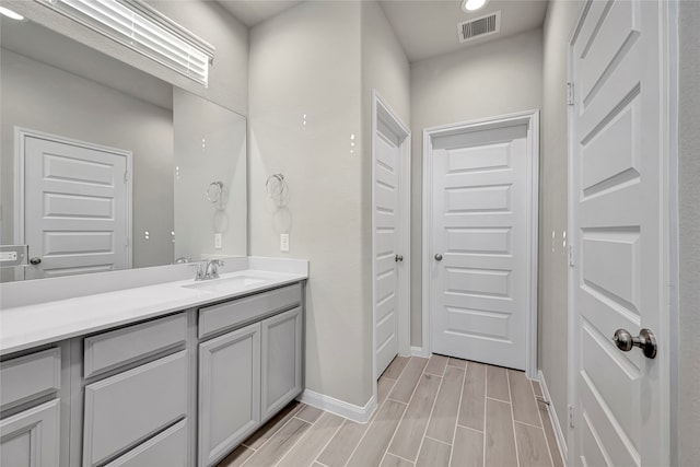 bathroom with vanity and hardwood / wood-style floors