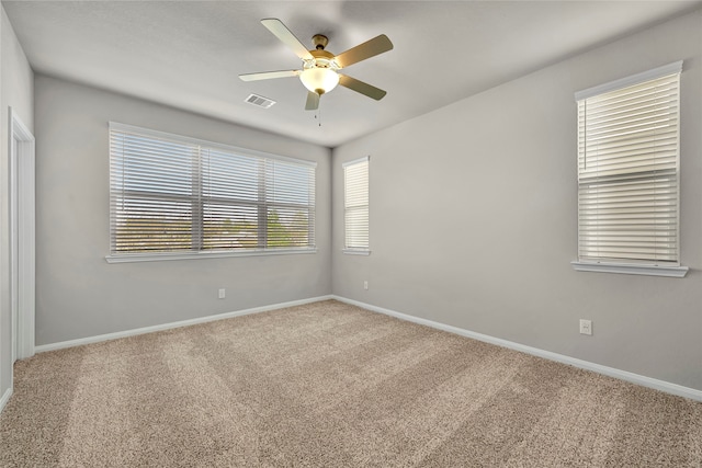 carpeted empty room featuring ceiling fan