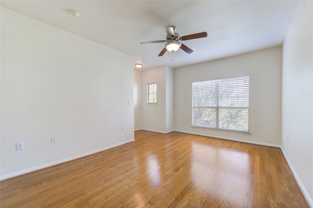 empty room with light wood-type flooring and ceiling fan