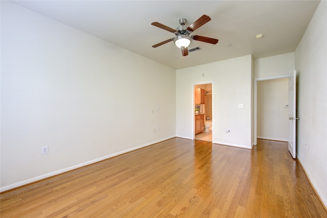 unfurnished bedroom featuring connected bathroom, ceiling fan, and light hardwood / wood-style flooring