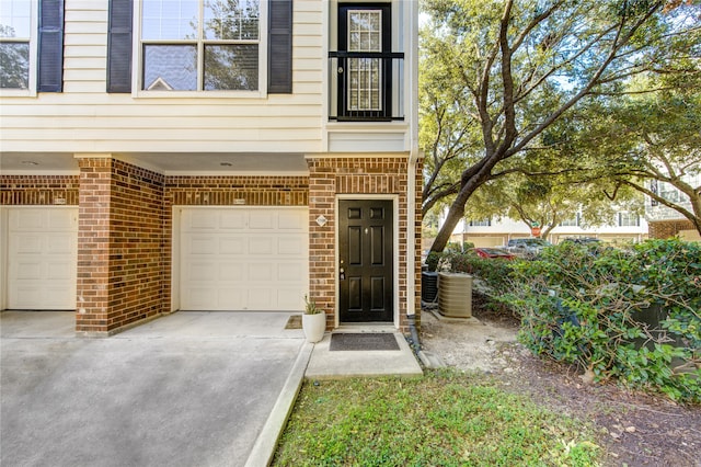 entrance to property with central AC and a garage