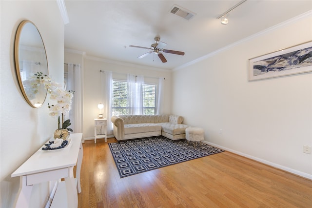 living room with ceiling fan, crown molding, track lighting, and hardwood / wood-style floors