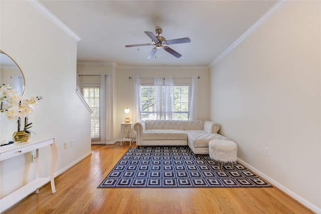 living room featuring ornamental molding, wood-type flooring, and ceiling fan