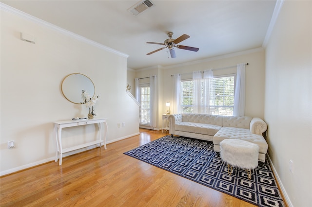 living room featuring ornamental molding, hardwood / wood-style floors, and ceiling fan