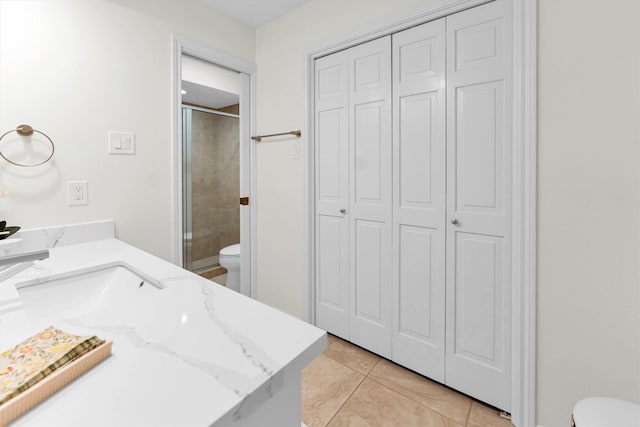 full bathroom featuring a closet, toilet, and a shower stall