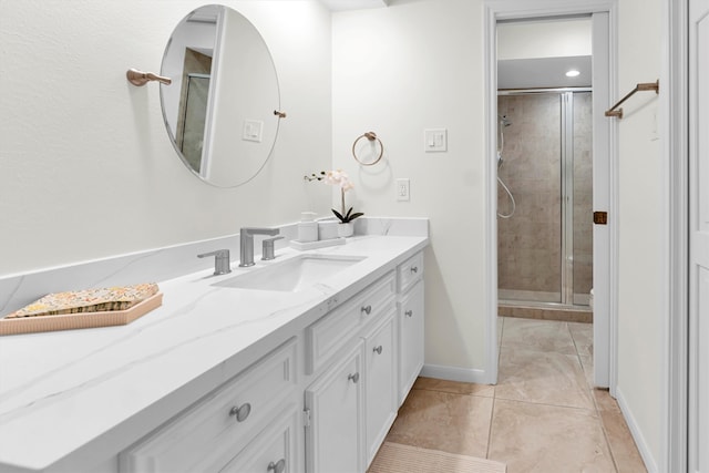 bathroom featuring vanity, walk in shower, and tile patterned flooring