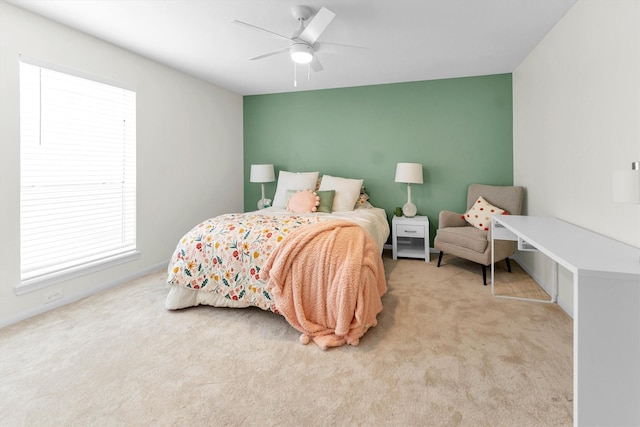 bedroom featuring baseboards, a ceiling fan, and light carpet