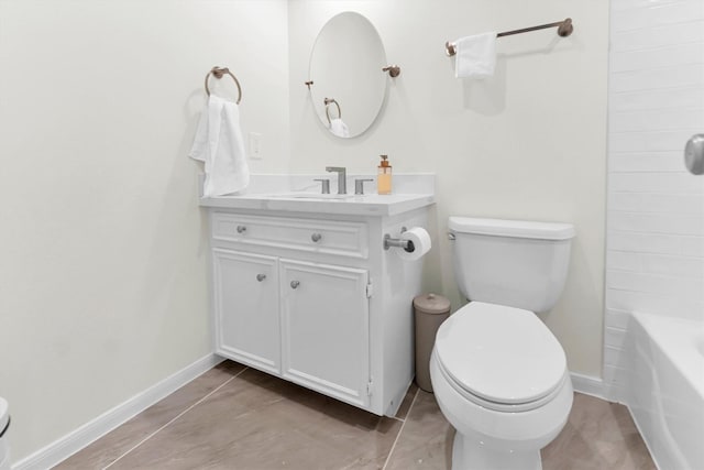 bathroom featuring toilet, baseboards, and vanity