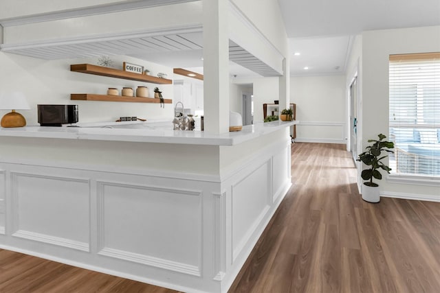 interior space with baseboards, recessed lighting, and wood finished floors