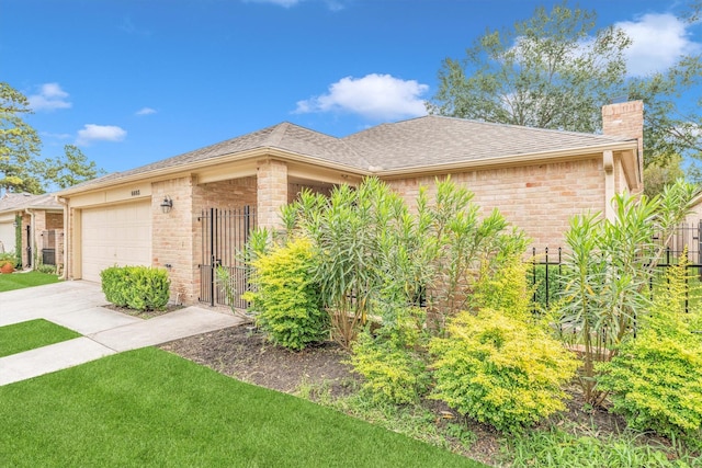 ranch-style house with a garage, a chimney, brick siding, a shingled roof, and driveway