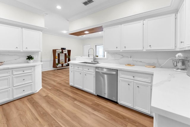 kitchen with visible vents, crown molding, dishwasher, a sink, and white cabinetry