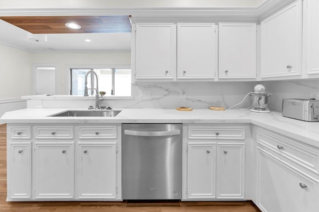 kitchen with ornamental molding, a toaster, white cabinetry, a sink, and dishwasher