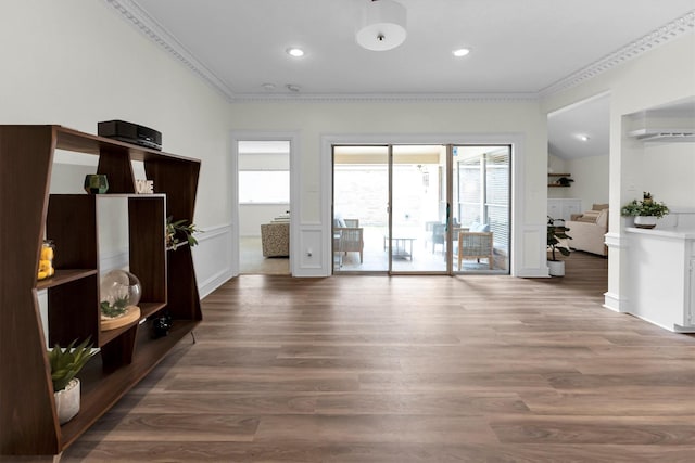unfurnished living room with ornamental molding, recessed lighting, and wood finished floors