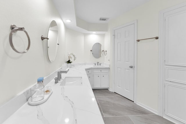 bathroom with recessed lighting, visible vents, two vanities, and a sink