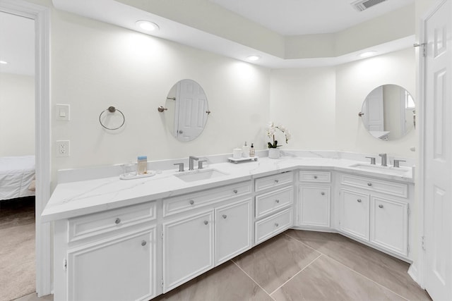 full bathroom featuring double vanity, recessed lighting, and a sink