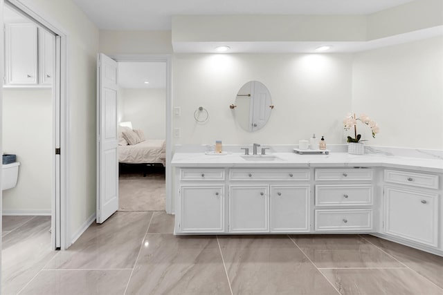 ensuite bathroom with recessed lighting, ensuite bath, and vanity