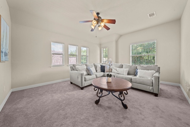 carpeted living room with ceiling fan and plenty of natural light