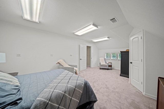 carpeted bedroom with lofted ceiling