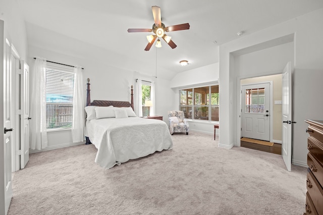 carpeted bedroom with vaulted ceiling and ceiling fan