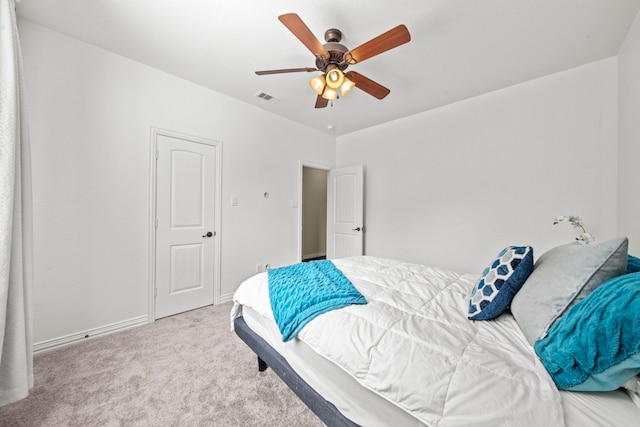 bedroom featuring light colored carpet and ceiling fan