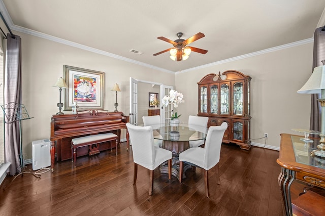 dining room featuring dark wood-type flooring, crown molding, plenty of natural light, and ceiling fan