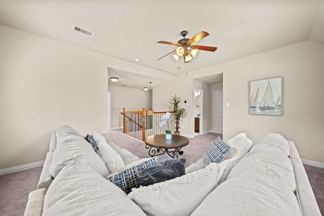 living room featuring carpet floors, vaulted ceiling, and ceiling fan