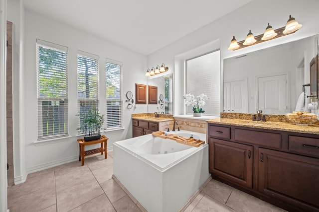 bathroom featuring vanity, a washtub, and tile patterned flooring