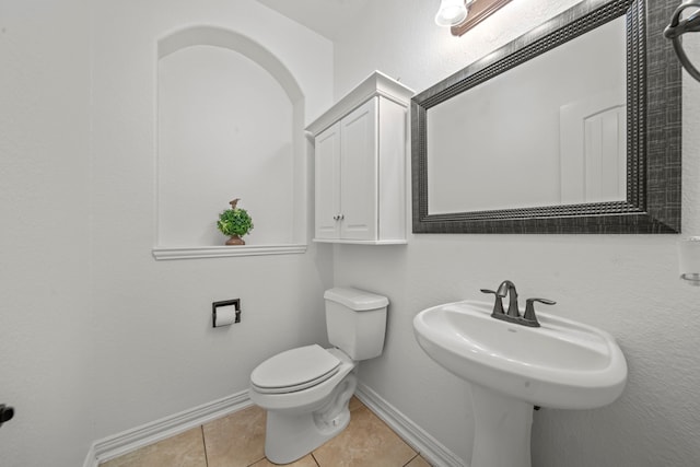 bathroom with toilet and tile patterned floors