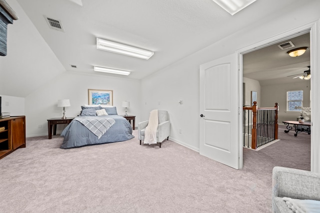 carpeted bedroom with vaulted ceiling, multiple windows, and ceiling fan