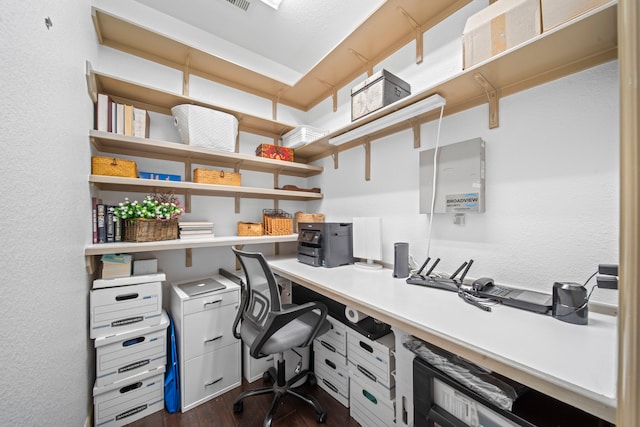 office featuring built in desk and dark hardwood / wood-style flooring