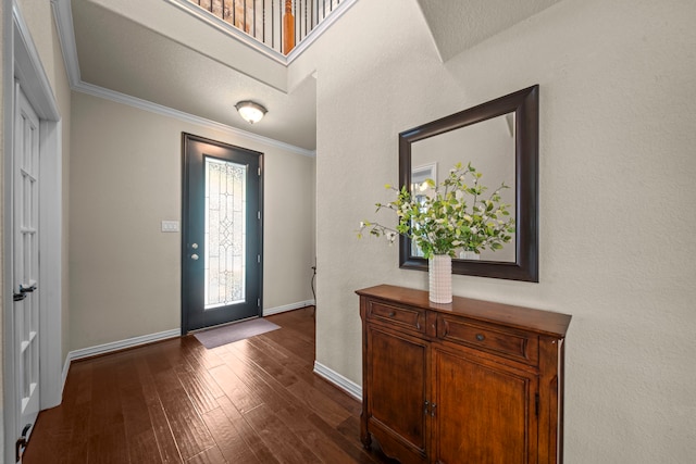 entryway featuring ornamental molding and dark hardwood / wood-style flooring