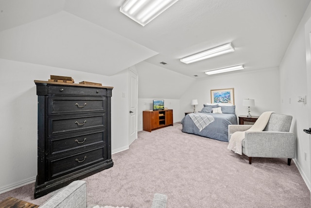 bedroom with lofted ceiling and light carpet