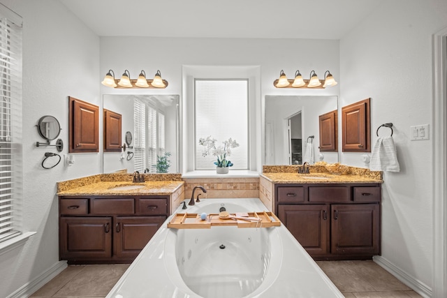 bathroom featuring vanity, a tub, and tile patterned flooring