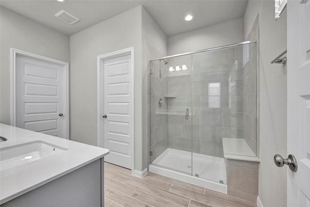 bathroom with vanity and an enclosed shower