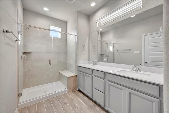 bathroom with vanity and a shower with door