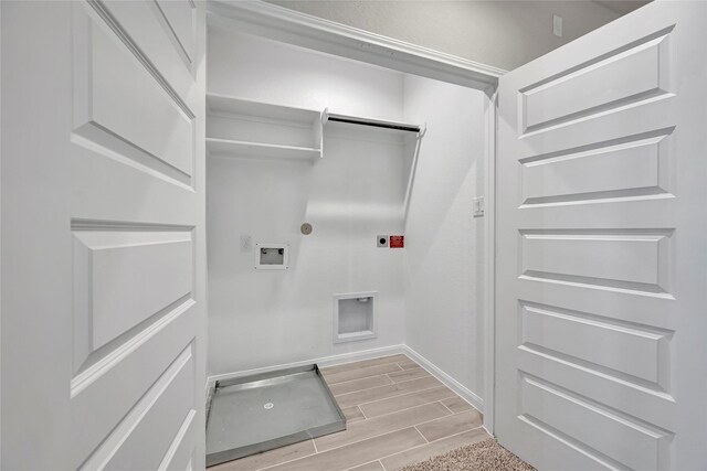 laundry area with hookup for a gas dryer, electric dryer hookup, washer hookup, and light wood-type flooring