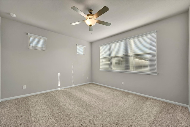 carpeted spare room with ceiling fan