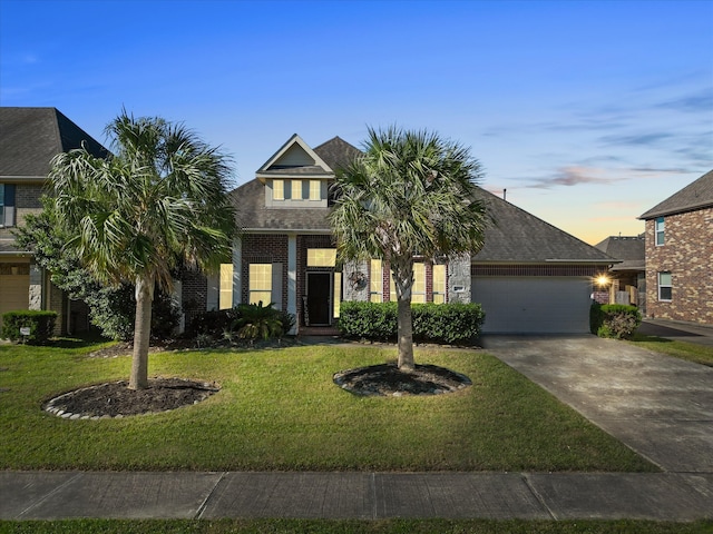 view of front of property with a lawn and a garage