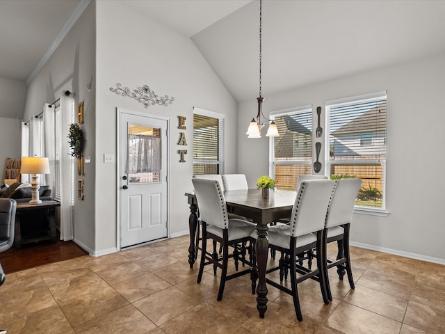 dining space featuring a notable chandelier, lofted ceiling, crown molding, and light tile patterned floors