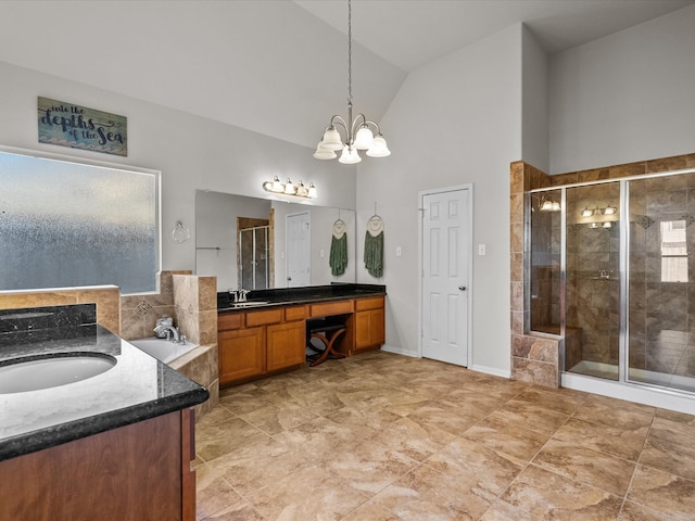 bathroom with vanity, shower with separate bathtub, high vaulted ceiling, and a chandelier