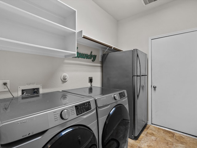 washroom featuring washer and dryer