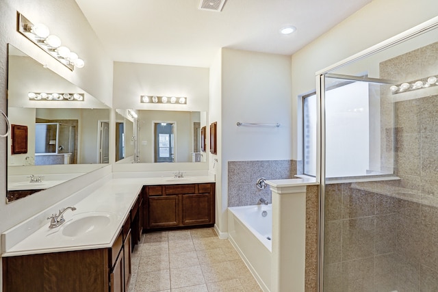 bathroom featuring vanity, shower with separate bathtub, and tile patterned flooring