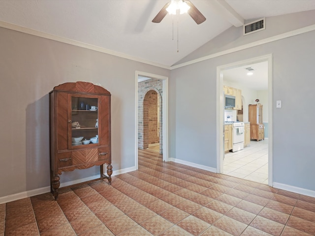 empty room with vaulted ceiling with beams, light tile patterned floors, and ceiling fan